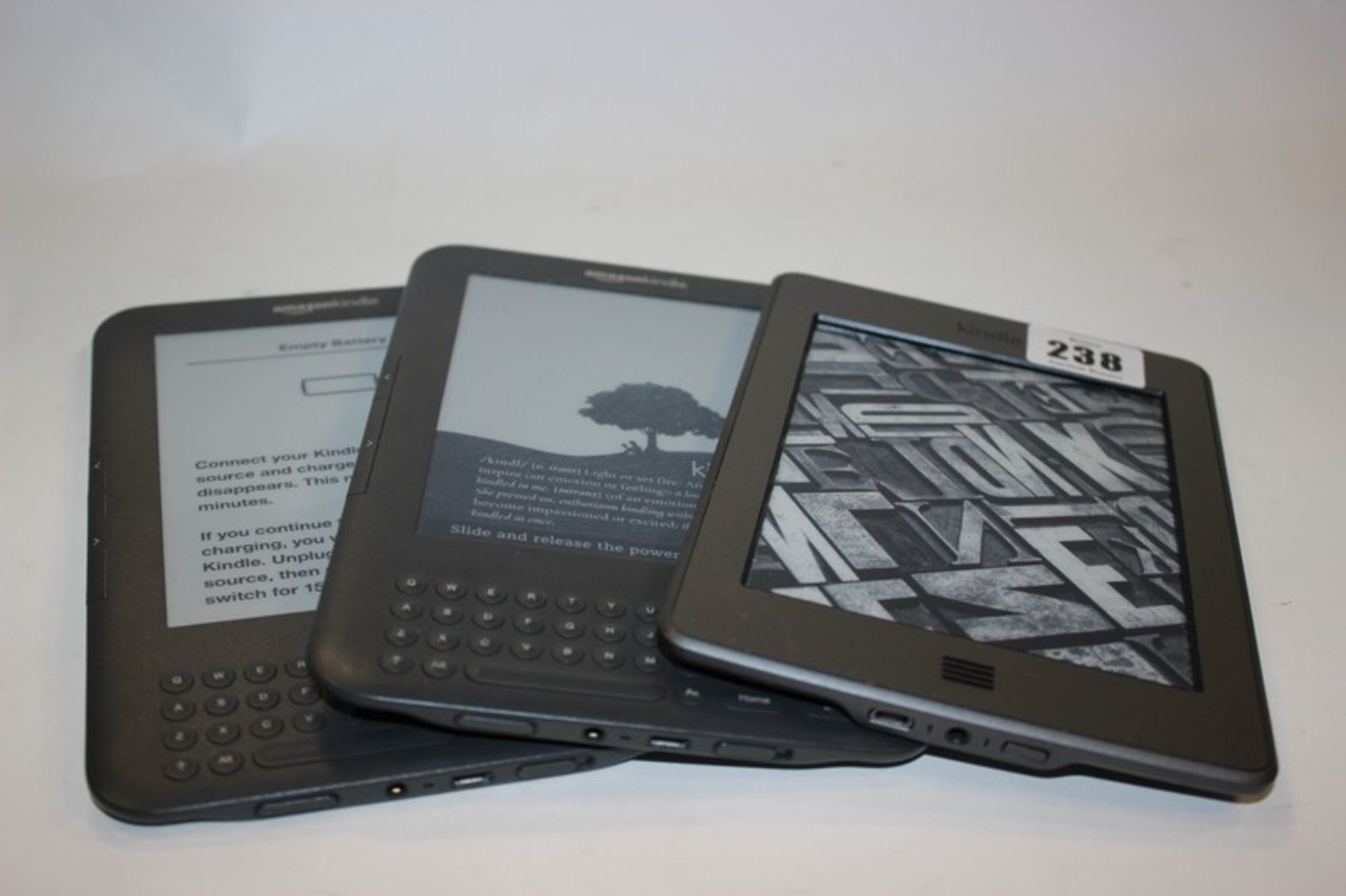 Two Kindle Keyboard model: D00901 and a Kindle Touch model: D01200.