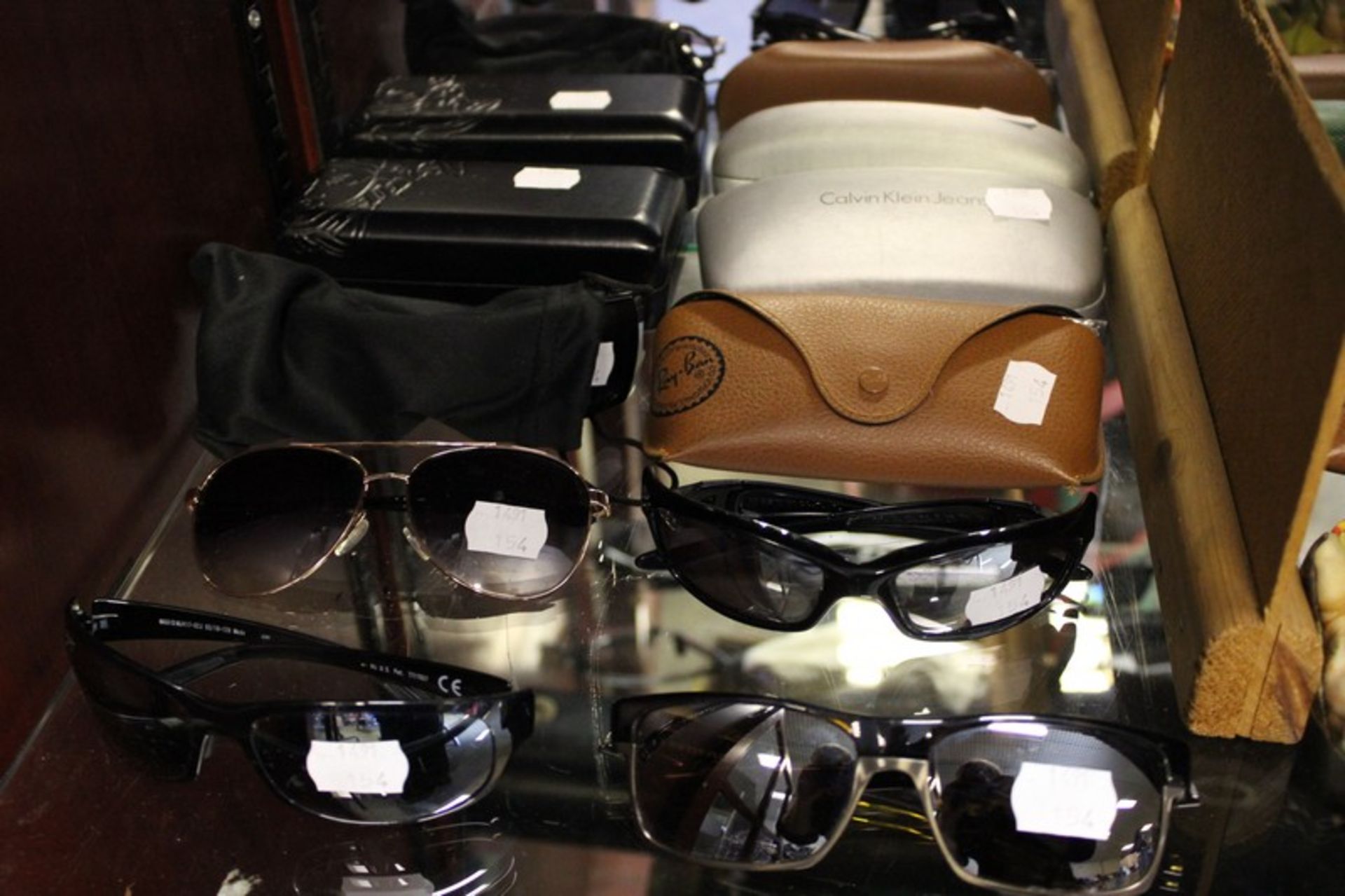 Eight pairs of branded sunglasses.