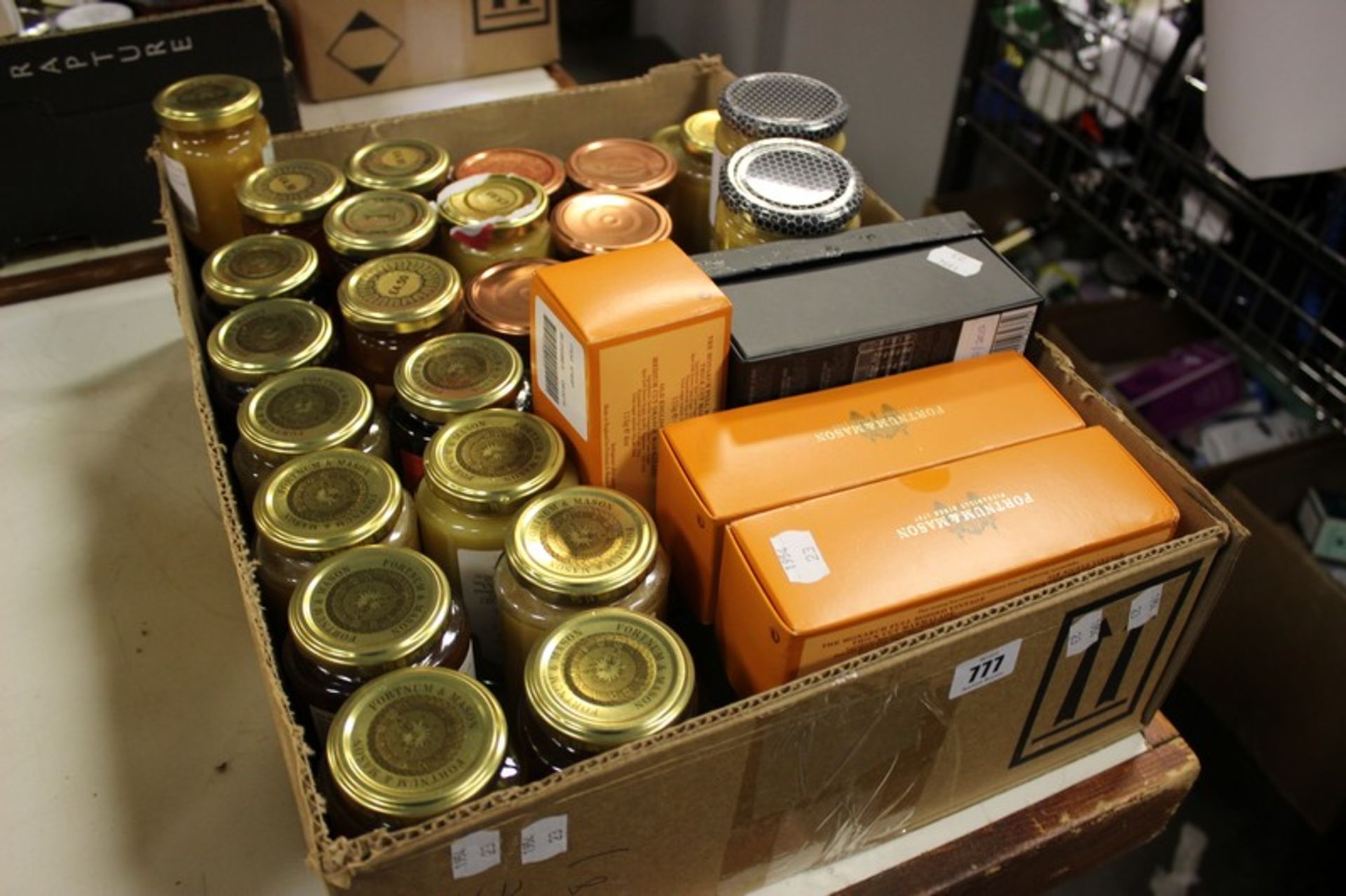 A box of Fortnum & Masons and Harrods jams/curds and three Manuka Honeys.