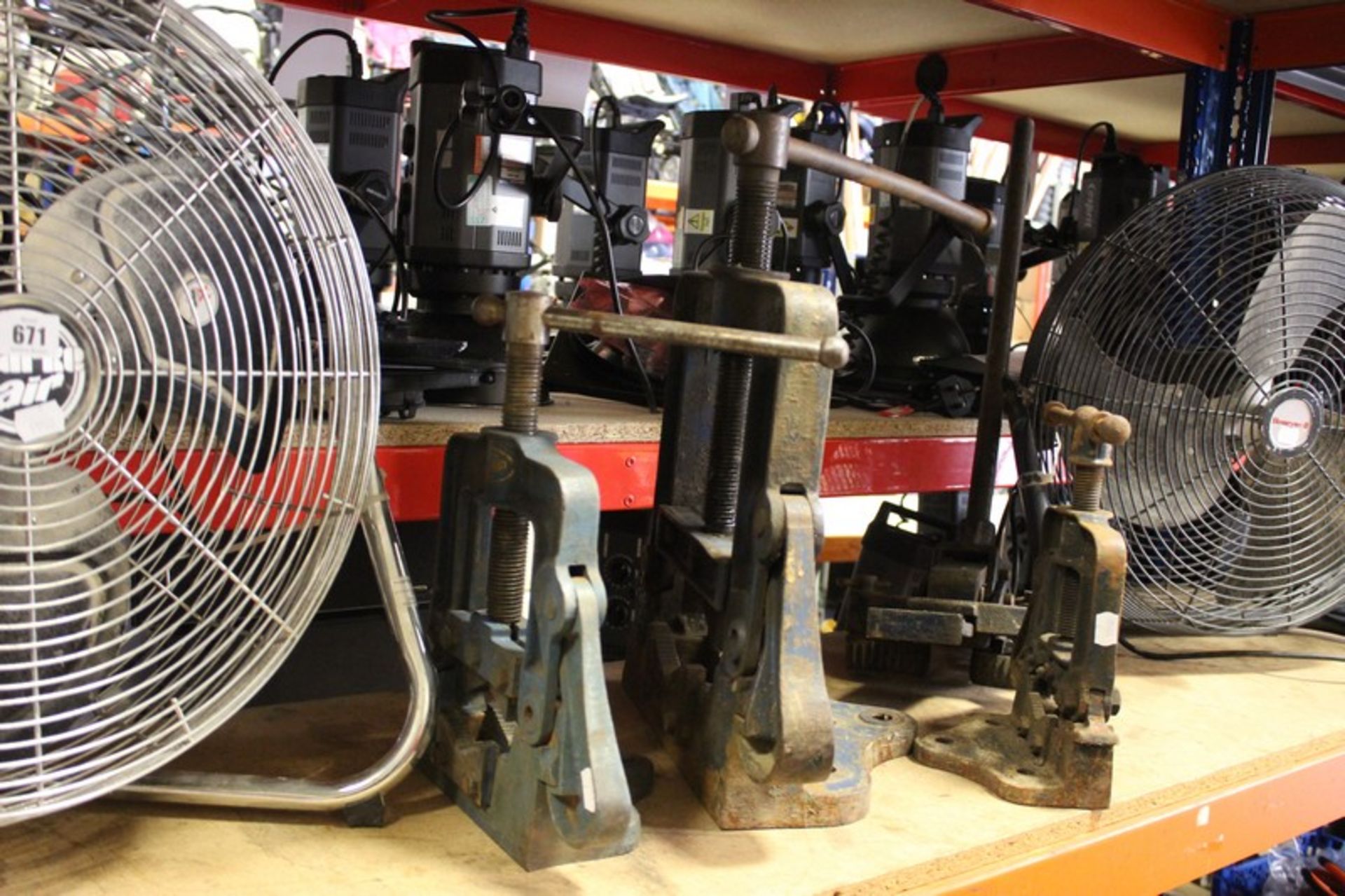 Three vintage pipe vices, a floor vice and two 240 volt floor fans.