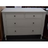 A Laura Ashley cream painted chest of drawers with two short over two long drawers with metal