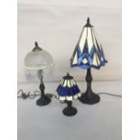 Two Tiffany style table lamps with metal base and geometric shade in white and blue 58cmH and 27cmH