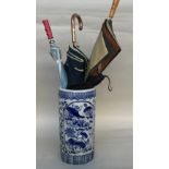 A ceramic umbrella stand of white ground with blue transfers of floral design 46cm together with 4