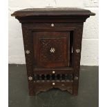 A small occasional carved wooden table with mother of pearl inlaid with Arabic writing