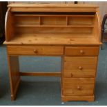 A modern pine roll top desk with internal divider over one long and three short drawers 105cmW