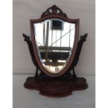 A Victorian carved mahogany dressing table mirror in the form of a shield,