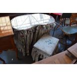 A kidney shaped white painted dressing table with glass top and removable curtains and covers of