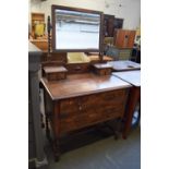 An oak dressing table with rectangular mirror with barley twist supports over two small drawers