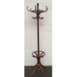 A 20th century bentwood coat stand in the manner of Thonet. Shaped legs to base with hooks atop.