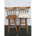 Two Windsor style spindle back high stools together with a cream cushion