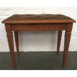 A double piano stool with button back light brown upholstered seat on square tapered legs