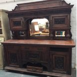 A continental sideboard with heavily carved doors,