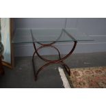 A mid century coffee table with rectangular glass top over metal bronze base,