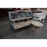 A wooden and cast iron slatted garden bench together with a metal garden table decorated with sheep