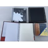 Four leather bound photo albums - one with self-adhesive pages the others slip in with writing