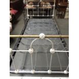 A white Victorian wrought iron single bed
