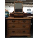 A Victorian pine mirror back dressing table with toilet mirror and drawer over two short and two