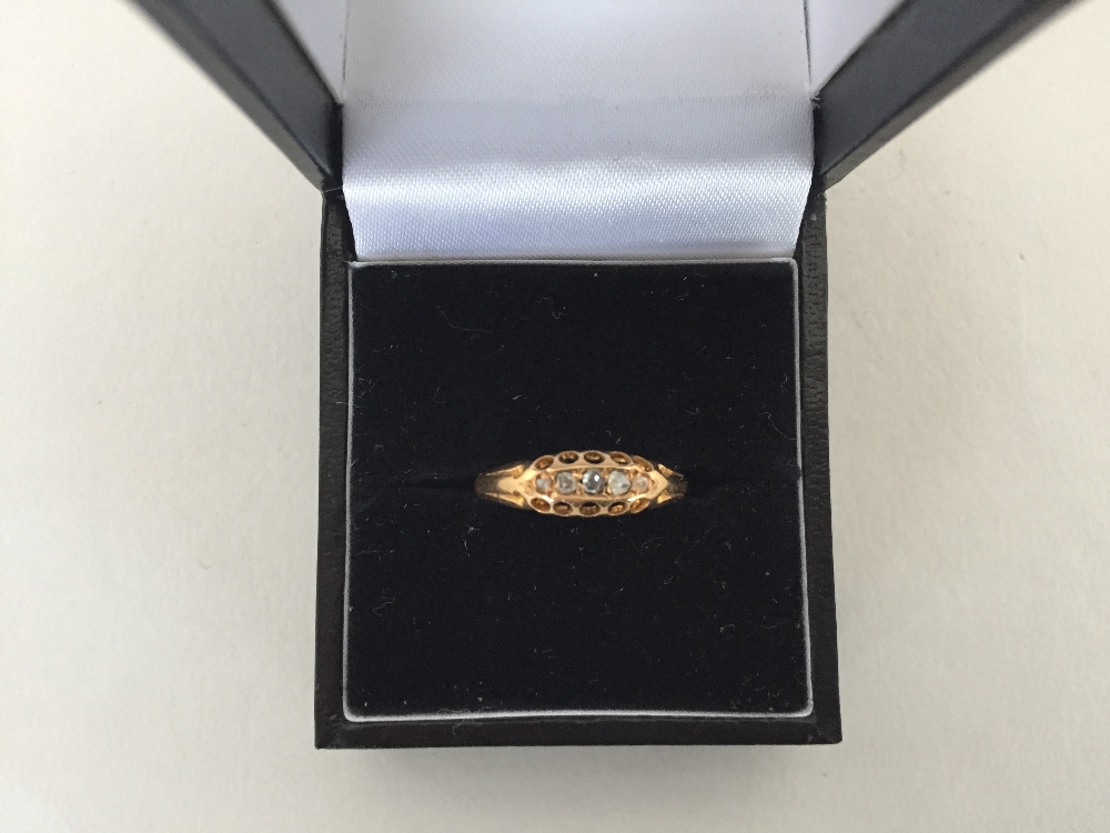 An 18ct gold ring with 5 diamond chips,