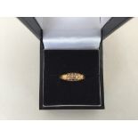 An 18ct gold ring with 5 diamond chips,
