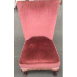 A nursing chair with cabriole legs and pink upholstery
