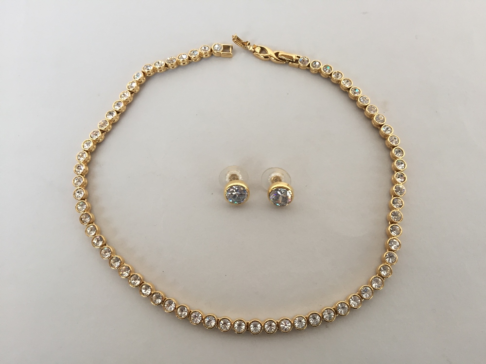 A yellow metal necklace with zirconia 40cm long signed Dorlan on the clasp with similar style