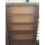 A pine bookcase with four shelves and carved pediment 83cmW