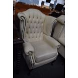 Two button back cream leather wingback armchairs on cabriole legs (2)