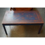 A rectangular coffee table with stencilled design