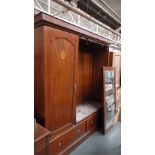 A large wardrobe with inlaid border and a central inlaid motif of mother of pearl with three panel