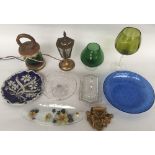 A selection of glassware including a green glass lamp with wooden frame