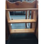 A pine wall hanging bookshelf with three shelves and carved top 61cmW