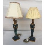 A pair of table lamps with a gilt lion above a fluted column with square base