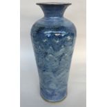 A tall studio pottery vase of marble blue glaze in the form of an urn with incised signature to