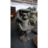 A composition stone statue of a cherub and an eagle holding aloft a round top 80cmH