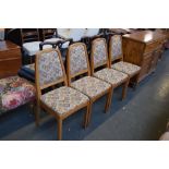 A set of four Parker Knoll pine kitchen chairs upholstered in colourful foliate design fabric