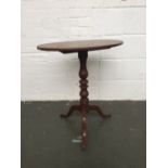 An oval tripod tip top side table with oval top (af) over turned base and tripod feet 68cmH