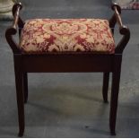 Upholstered piano stool with hinged seat and scrolling turned handles.