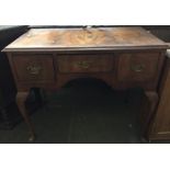 A mahogany occasional desk with three drawers and cabriole legs 90 x 90 x 75cmH