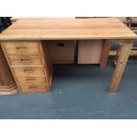 A modern pine kneehole mid-century desk with five drawers 120cmW