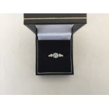 An 18ct gold ring with central aquamarine stone with a diamond chip each side (wt 2gr overall)