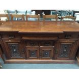 A Victorian walnut sideboard with carved panelled decoration comprising of three drawers including