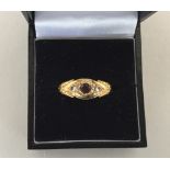 An 18ct gold ring with small ruby and two diamond chips, hallmarked Pendleton & Sons,