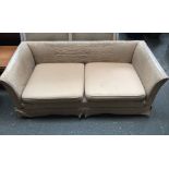 A three seater sofa with cream upholstery,
