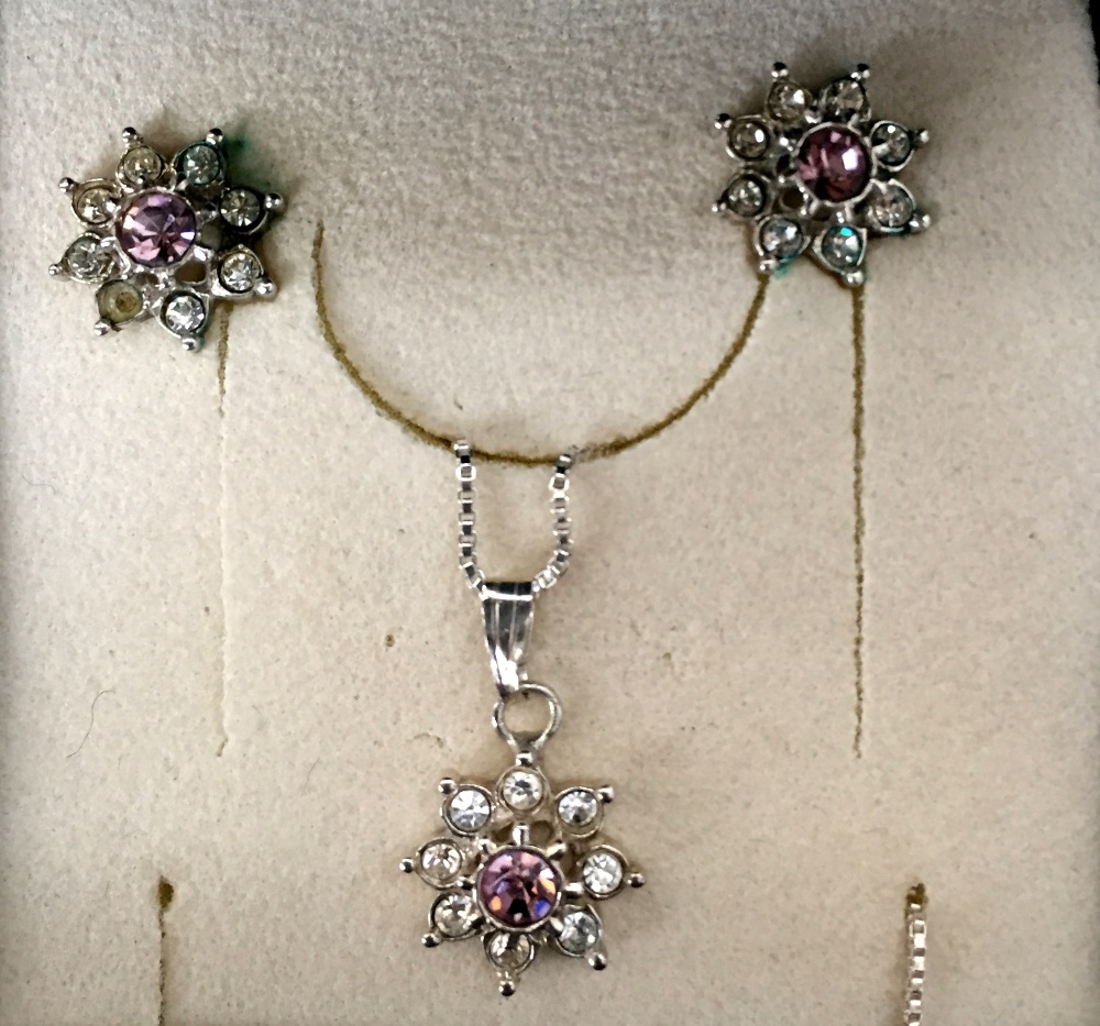 A silver plated set comprising of silver square link chain with pendant in the form of a flower