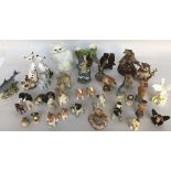 A quantity of figurines both wooden and ceramic including dogs, cats,