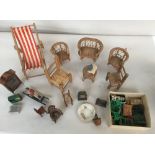 A box of doll's house furniture including a whicker table and chairs, deck chair, a rocking horse,