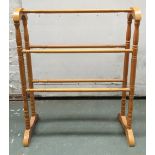 An arch top towel rail with turned support