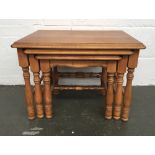 A nest of three pine side tables on turned legs 64cmW