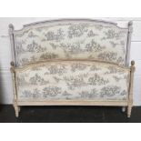 A double French bed with a grey and cream toile de Jouy upholstered headboard and footboard
