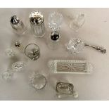 A small selection of cut glass items to include two salt and pepper sets, a napkin ring,